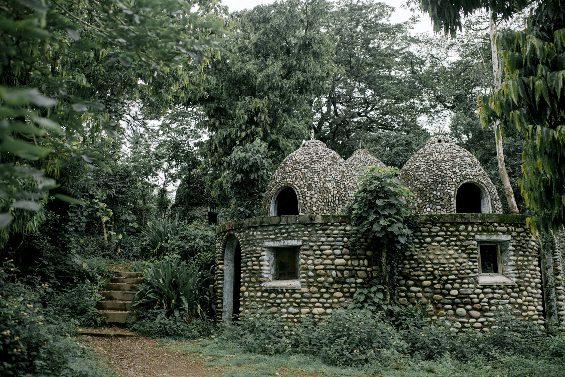 old stone buddhist meditation house in green garden
